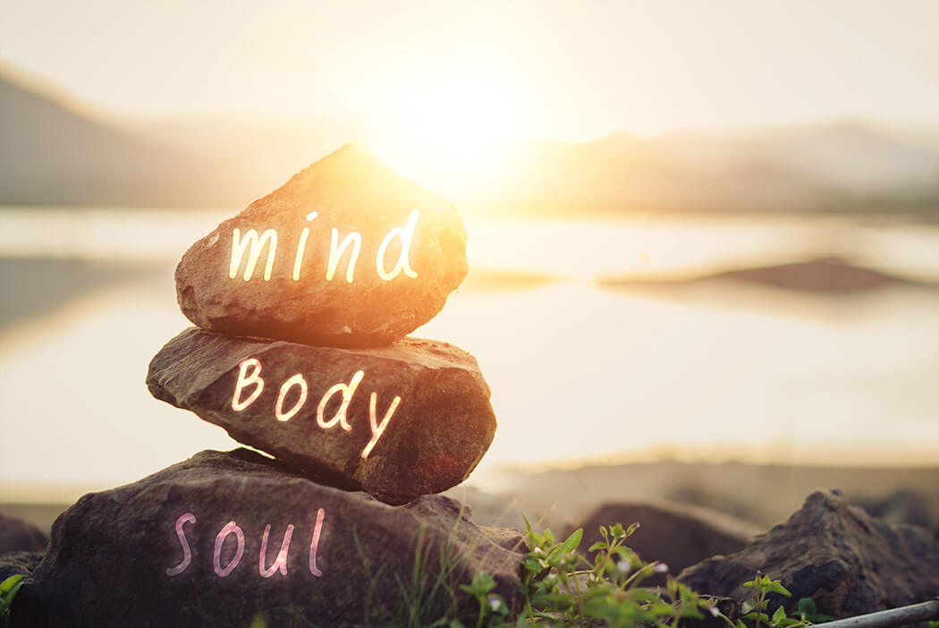 mind body and soul written on three rocks